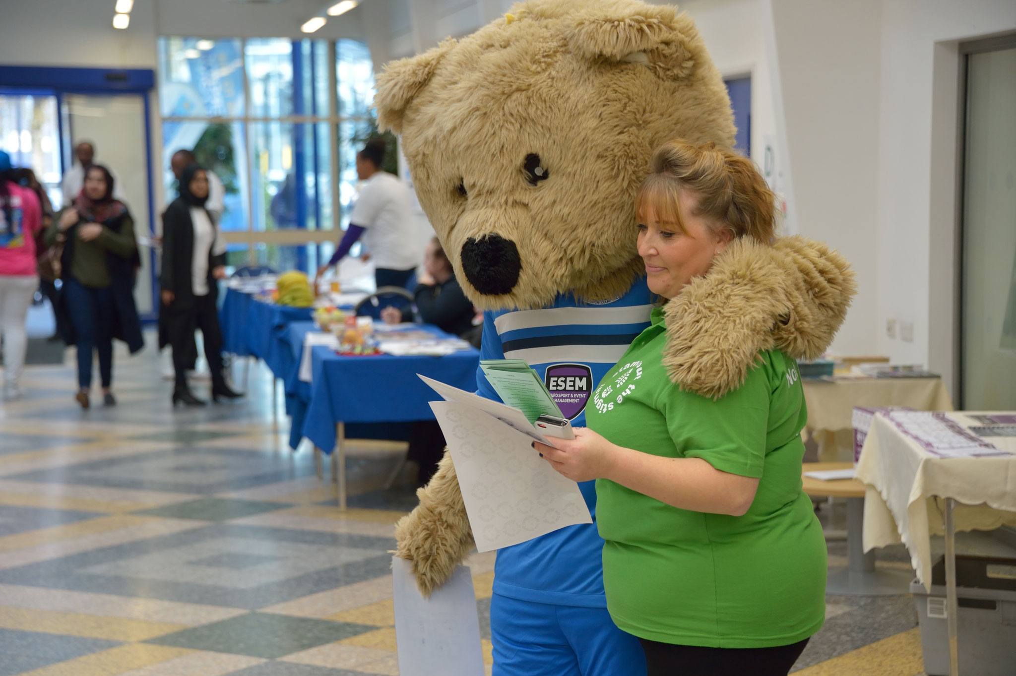 Student and mascot at a health promotion event at the University of Bolton